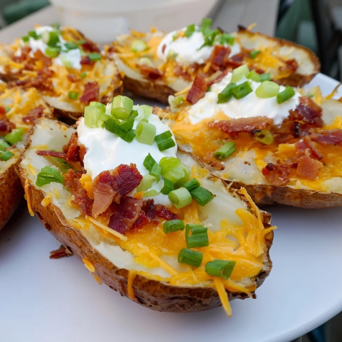 Golden, crispy Loaded Baked Potato Skins, generously topped with melted cheese and crumbled bacon.