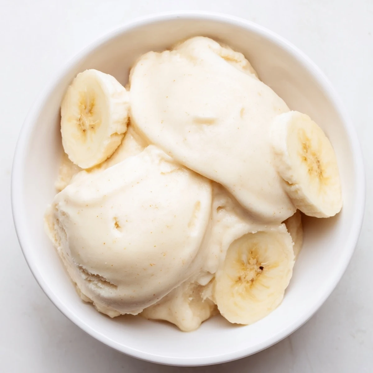 A swirl of creamy 2-Ingredient Banana Ice Cream, a perfect dairy-free and healthy dessert.