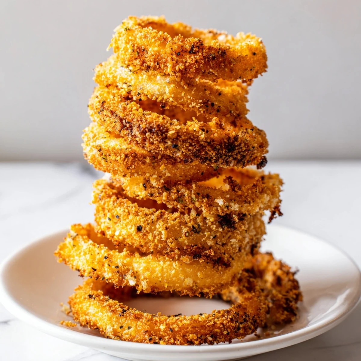 Perfect for a party, this visually impressive Crispy Onion Ring Tower offers satisfying crunch and savory flavors.