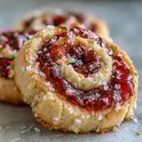 A close-up of Raspberry Swirl Shortbread Cookies highlighting the vibrant jam swirl on buttery shortbread.