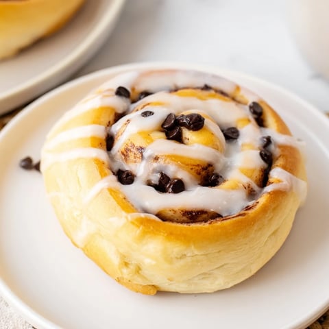 Warm, freshly baked Nutella Chocolate Chip Rolls with a gooey hazelnut swirl and melted chocolate chips, ready to serve as a decadent breakfast or dessert.