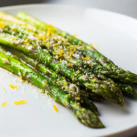 A close-up of the roasted asparagus with Parmesan cheese and lemon zest, ready to serve.