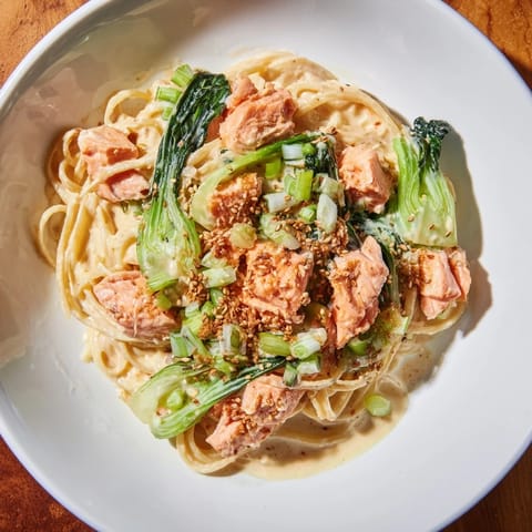 Creamy miso butter salmon pasta served with a sprinkle of scallions, ready to enjoy.